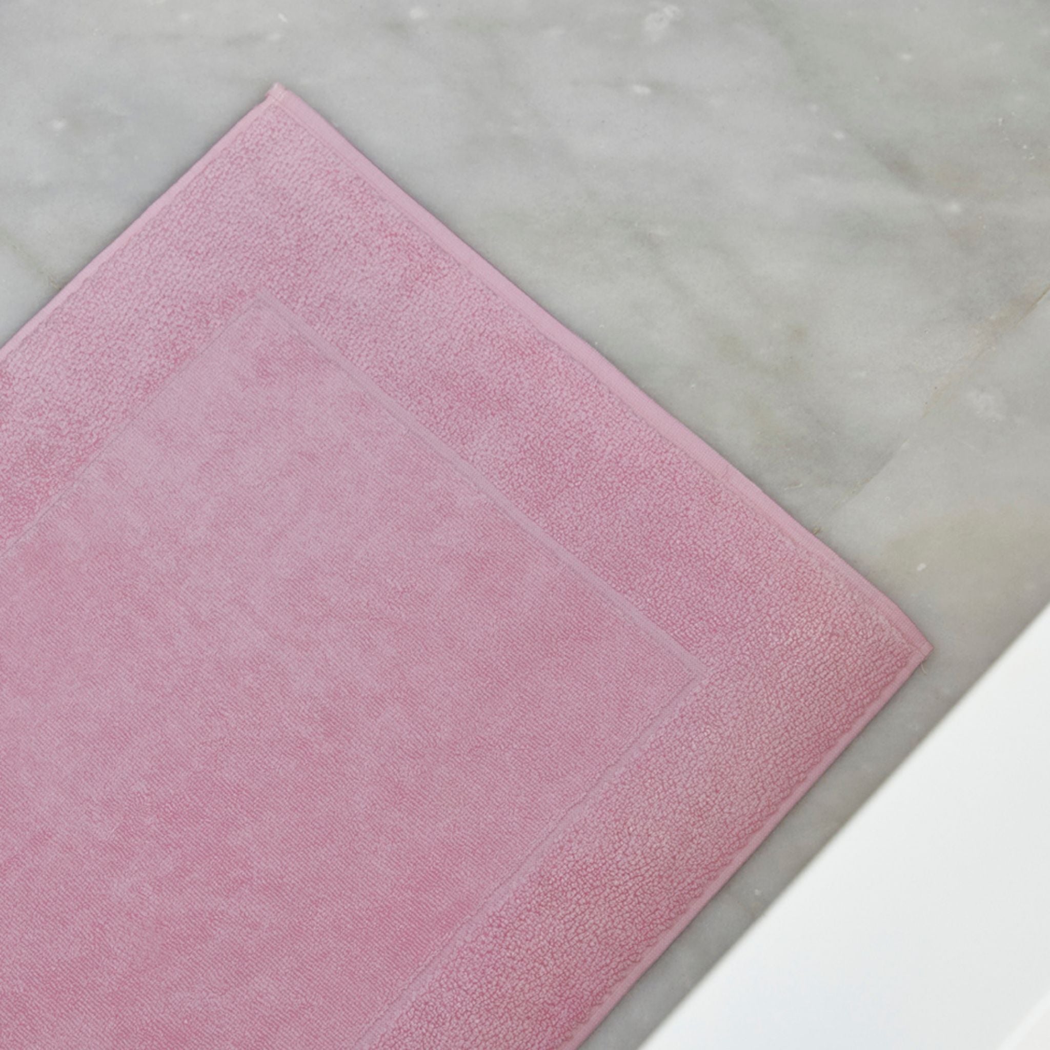 Old pink bath mat