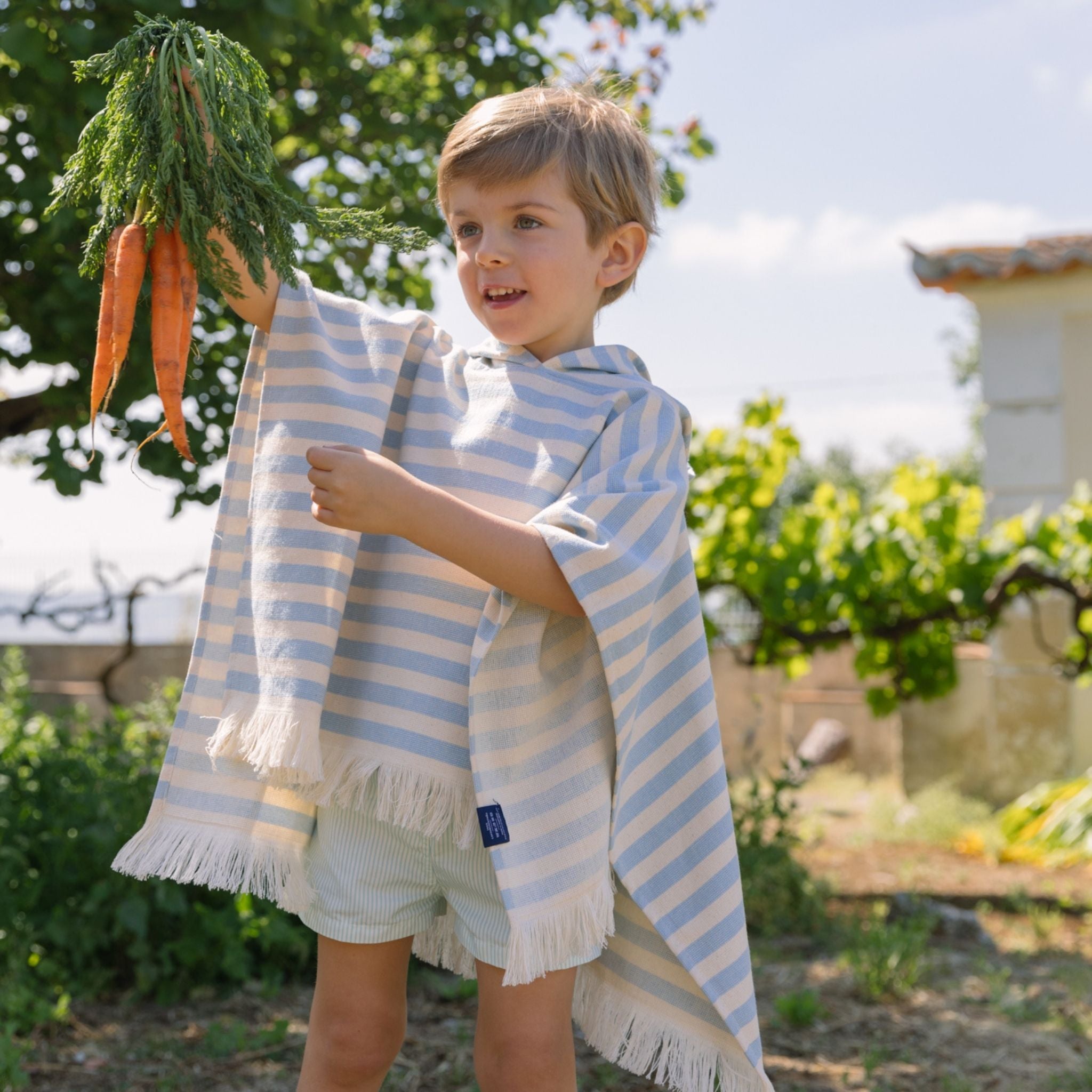 torres-novas-beach-barra-horizontal-stripes-kid-poncho-blue-sky-lifestyle-4.jpg