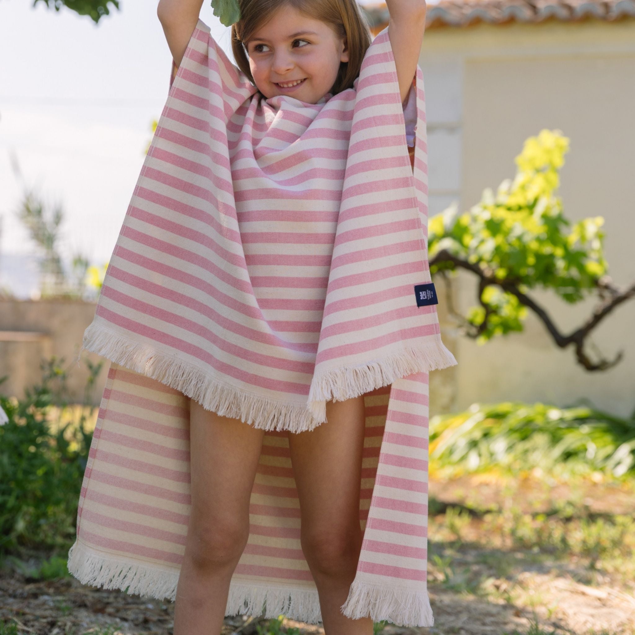 torres-novas-beach-barra-horizontal-stripes-kid-poncho-pink-lifestyle-3.jpg