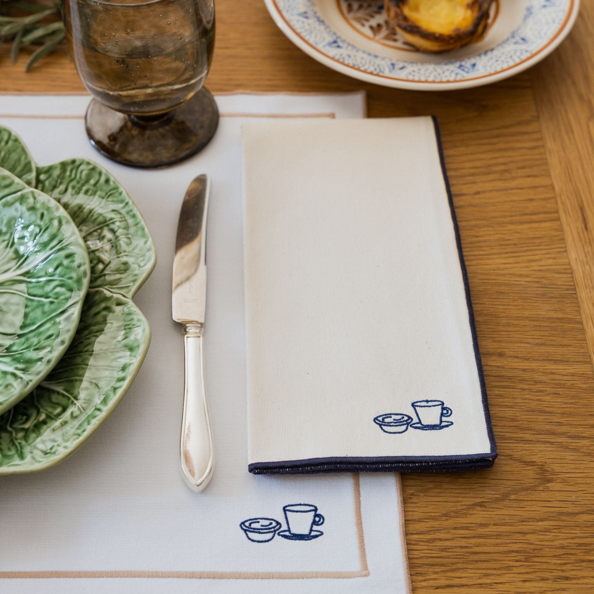 Nazaré ecru cotton table linen with embroidered Portugal-inspired motifs