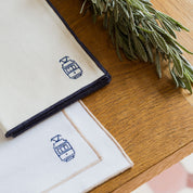 Nazaré ecru cotton table linen with embroidered Portugal-inspired motifs