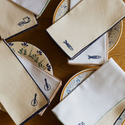 Nazaré ecru cotton table linen with embroidered Portugal-inspired motifs